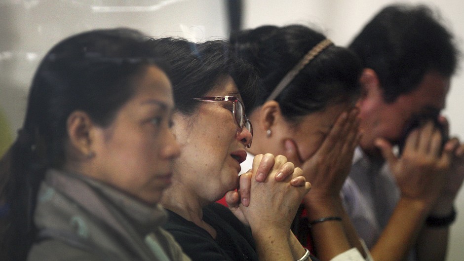 Relatives and next-of-kin of passengers on the AirAsia flight QZ8501 wait for the latest news in Surabaya (AP)