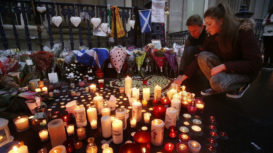 Candles are lit in Royal Exchange Square, adjoining Queen Street, in Glasgow, to remember victims of the bin lorry crash