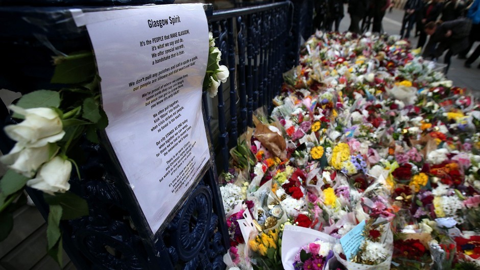 Flowers left at Ingram Street in Glasgow as police remove the cordons at the scene of yesterday's bin lorry crash in the city