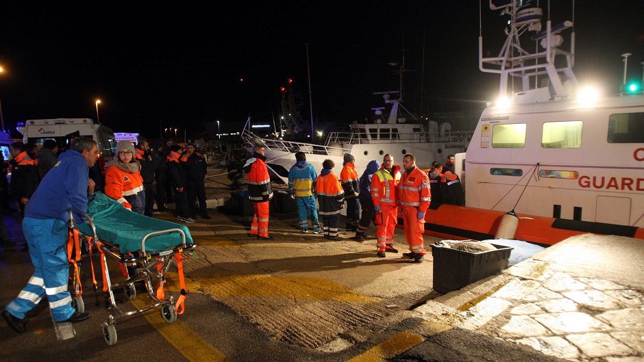Paramedics wait for rescued passengers from the ferry to arrive at the Otranto harbour, near Lecce, southern Italy (AP)