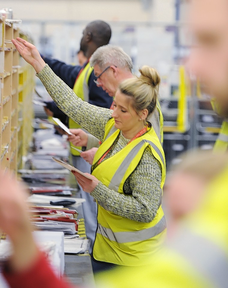 Royal Mail in Aberdeen sorting cards and parcels on the busiest day of the year for the organisation