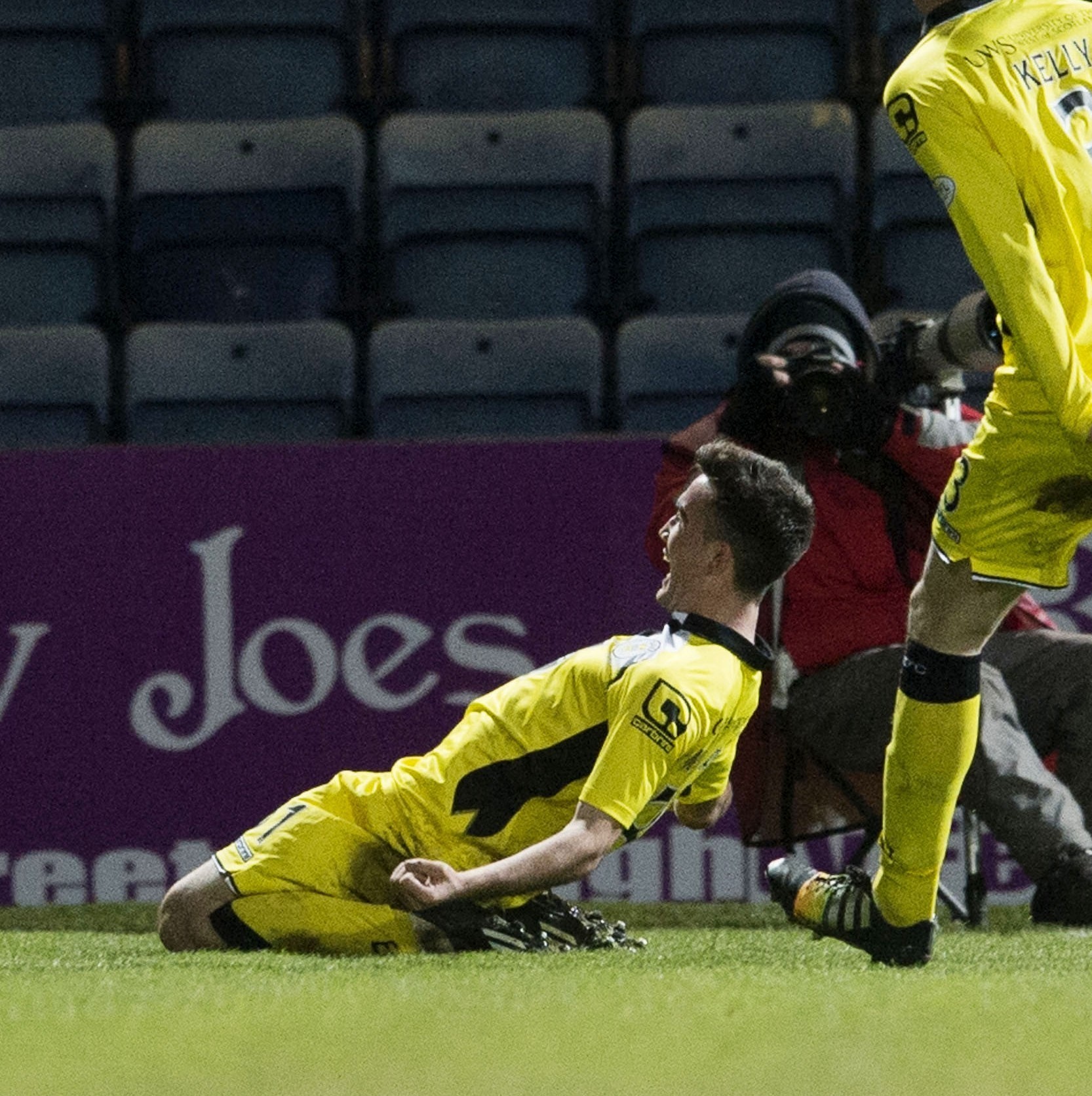 Stephen Mallan slides to the ground and celebrates his stunning goal