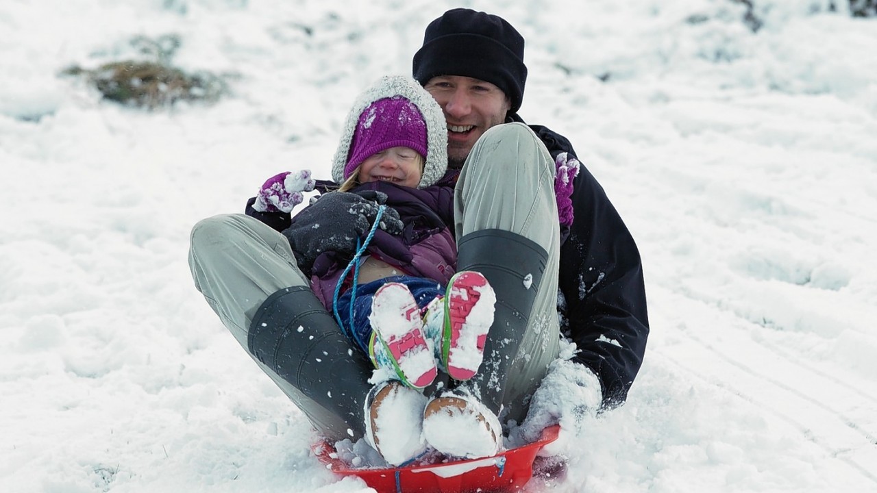 Stuart Thomson from Nairn makes the most of the snow above Aviemore 2 year old Iona.  Picture: Paul Campbell