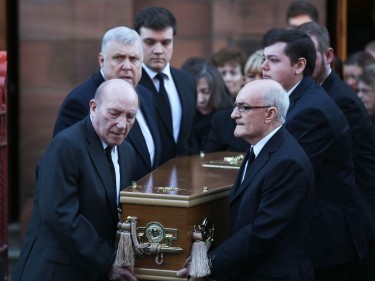 A coffin leaves the church