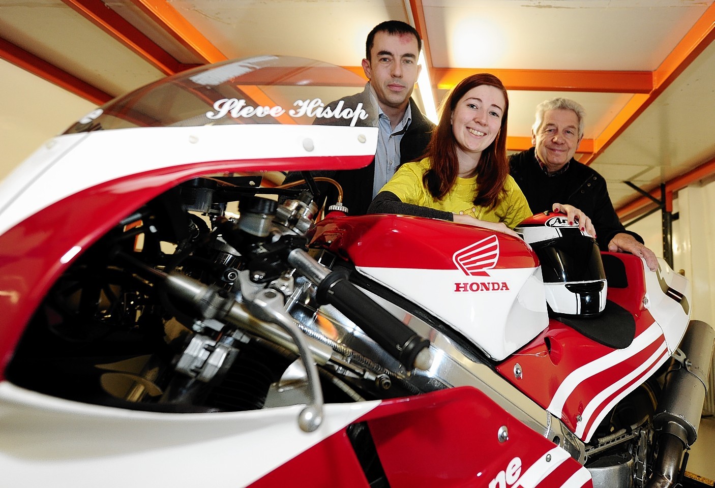 From left to right: Andy Freeman event organiser, Archie Fundraising manager Emma Slesser and Sandy Dalgarno (owner of the bike) with the 1989 Steve Hislop TT winning Honda RC30 which will be on display at the event.