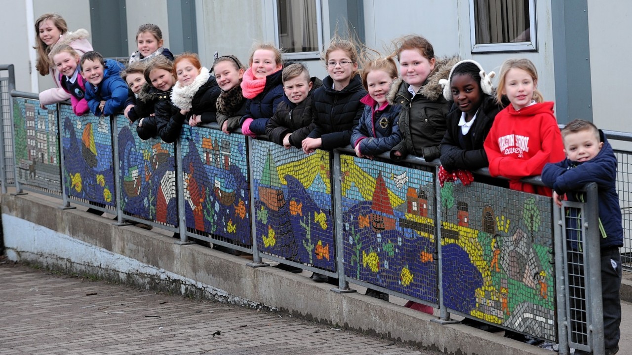 The pupils proudly display their masterpiece