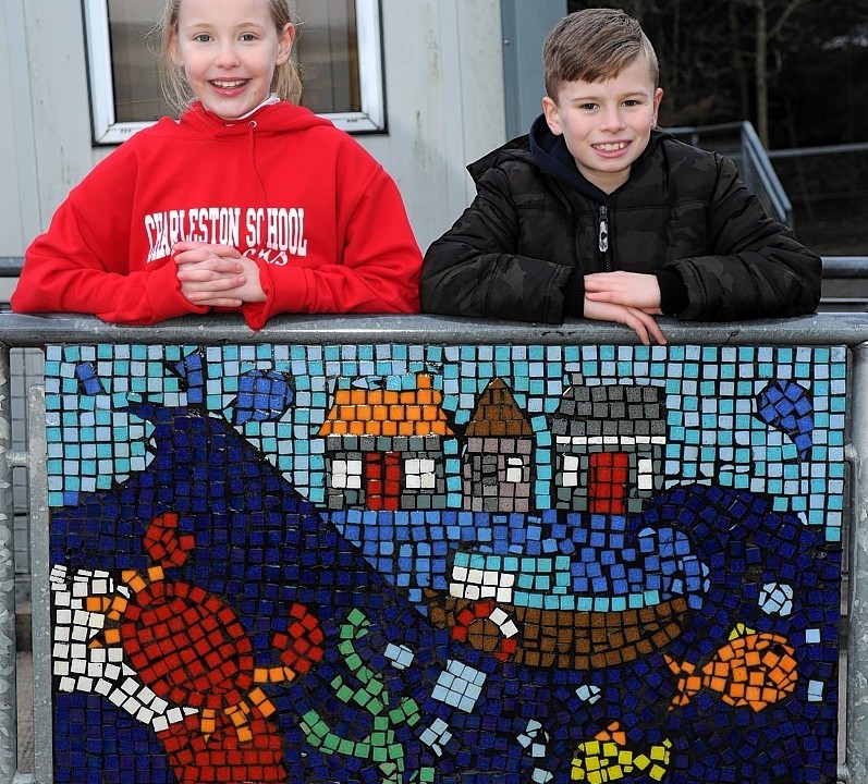 The pupils proudly display their masterpiece