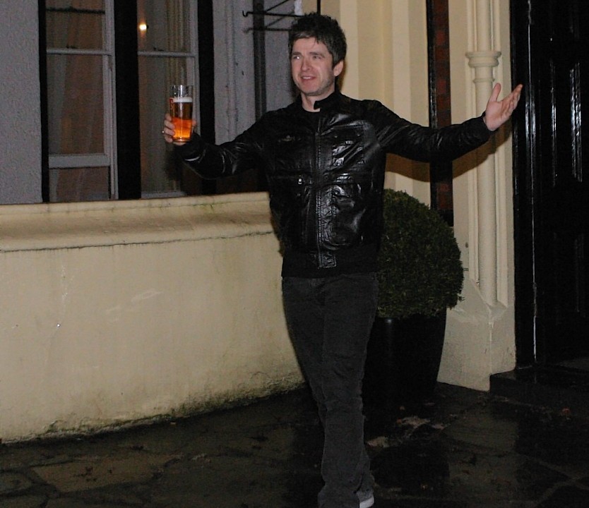 Noel Gallagher signs autographs outside the hotel