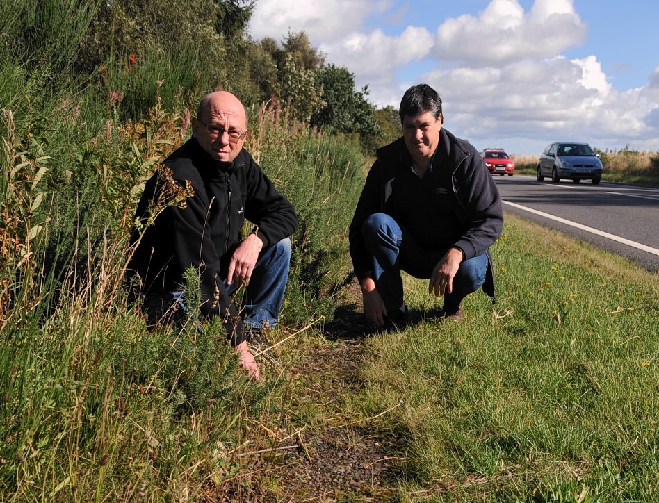 Campaign leaders Jim Rogers, left, and Neil Jeronim on the overgrown cycle path next to the A96, between Forres and Brodie