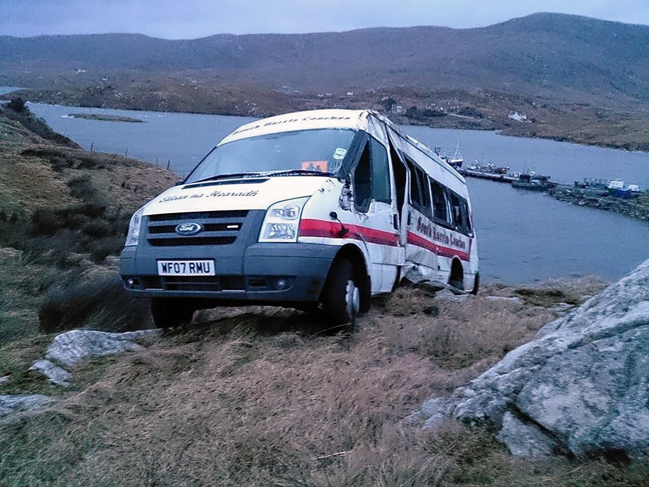 The 16-seater minibus hanging over the edge of the cliff on Isle of Scalpay