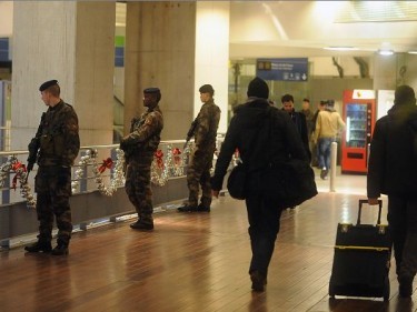 Military personnel patrol the Gare du Nord railway station