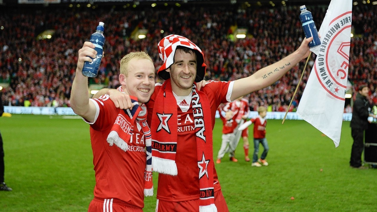 Nicky Low, left, and Niall McGinn celebrate the 2014 League Cup final win.