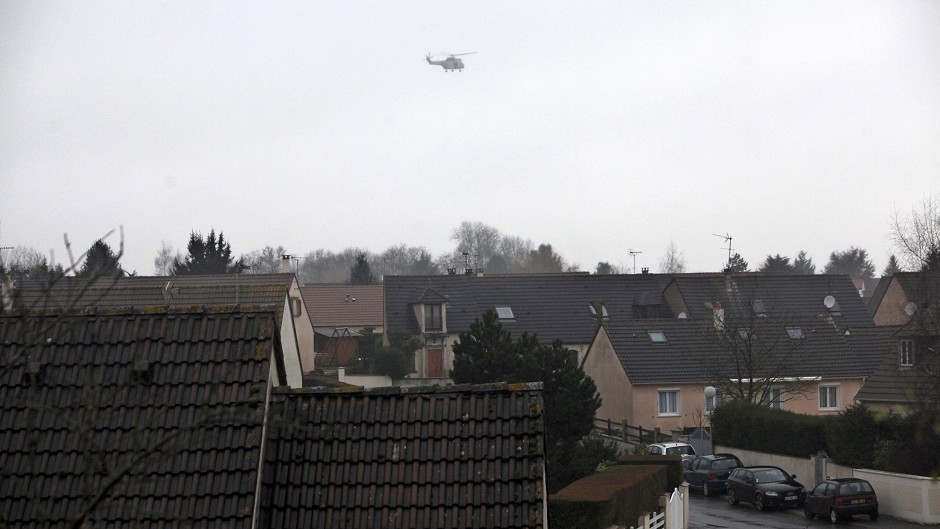 A police helicopter flies over Dammartin-en-Goele, north-east of Paris, as French security forces tried to capture a pair of heavily armed suspects in the deadly storming of a satirical newspaper (AP)
