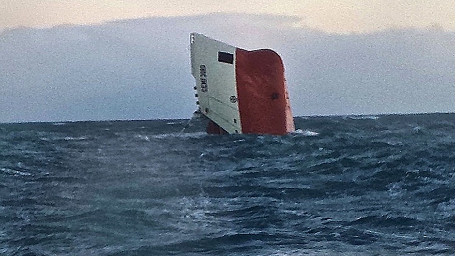 The Cemfjord cargo ship after it overturned off the north coast of Scotland (RNLI/PA)
