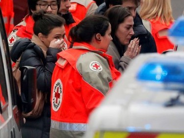  People react as they are evacuated outside the French satirical newspaper Charlie Hebdo's office