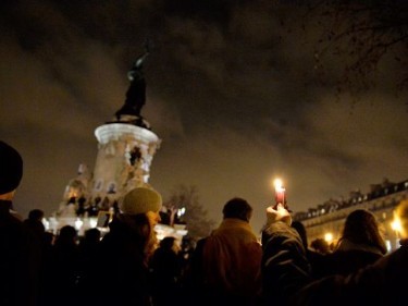 People gather around candles and pens at the Place de la Republique (Republic square) in support of the victims after the terrorist attack 