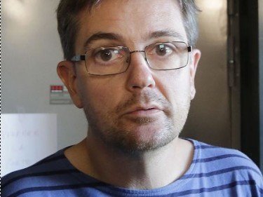In this Sept.19, 2012 file photo, publishing director of the satirical weekly Charlie Hebdo, Charb, talks to the media in Paris. Masked gunmen shouting "Allahu akbar!" stormed the Paris offices of the satirical newspaper Wednesday Jan. 7, 2015, killing 12 people, including Charb,  including the editor and a cartoonist before escaping