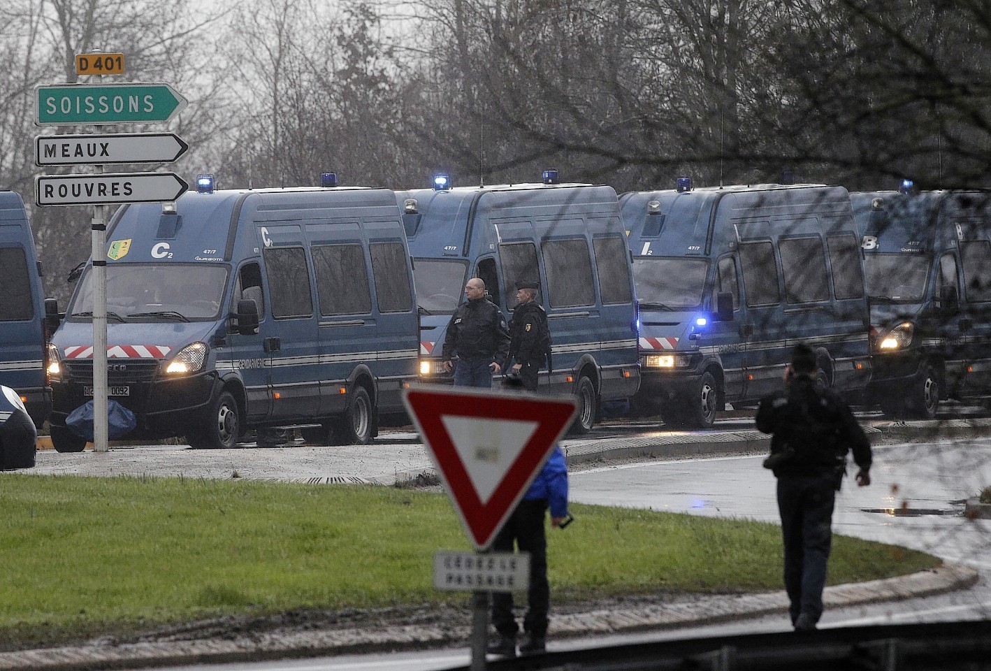 Police vans are lined up in Dammartin-en-Goele, northeast Paris, as part of an operation to seize two heavily armed suspects, 