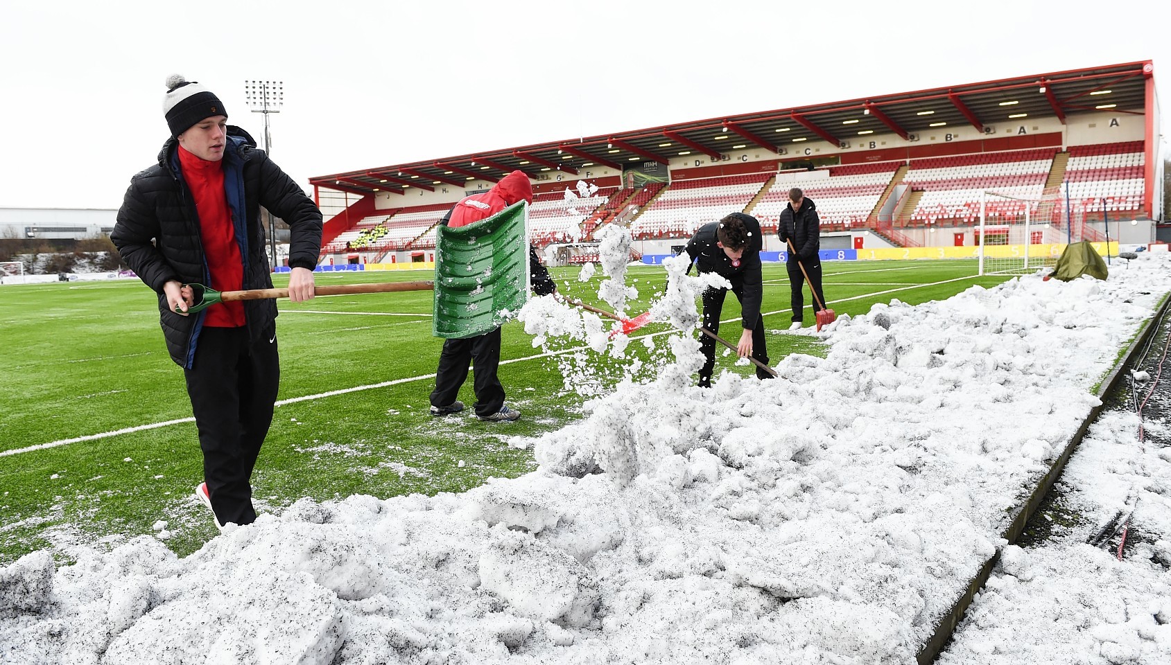 Hamilton Accies v Celtic: Fans cleared snow from the pitch prior to kick off at New Douglas Park
