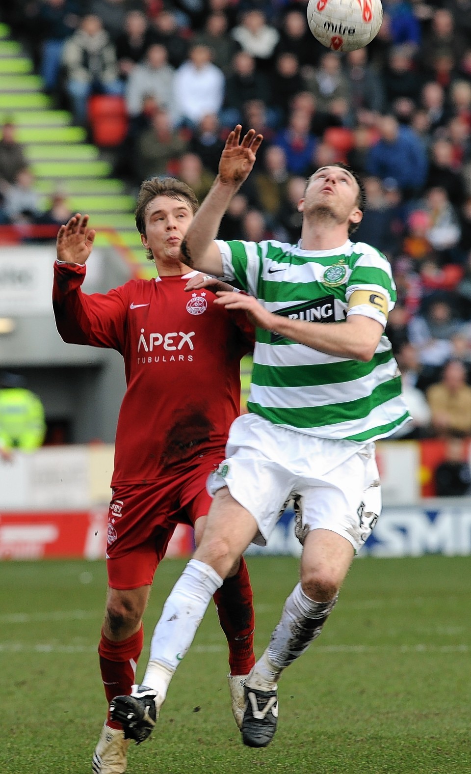 Stephen McManus challenges Darren Mackie while captain of Celtic