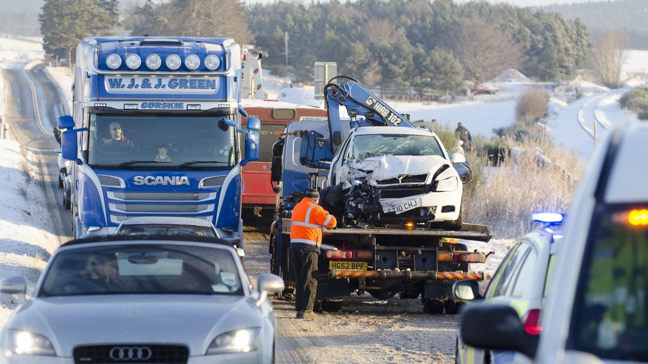 Vehicles file carefully past the totalled 2010 Skoda Octavia