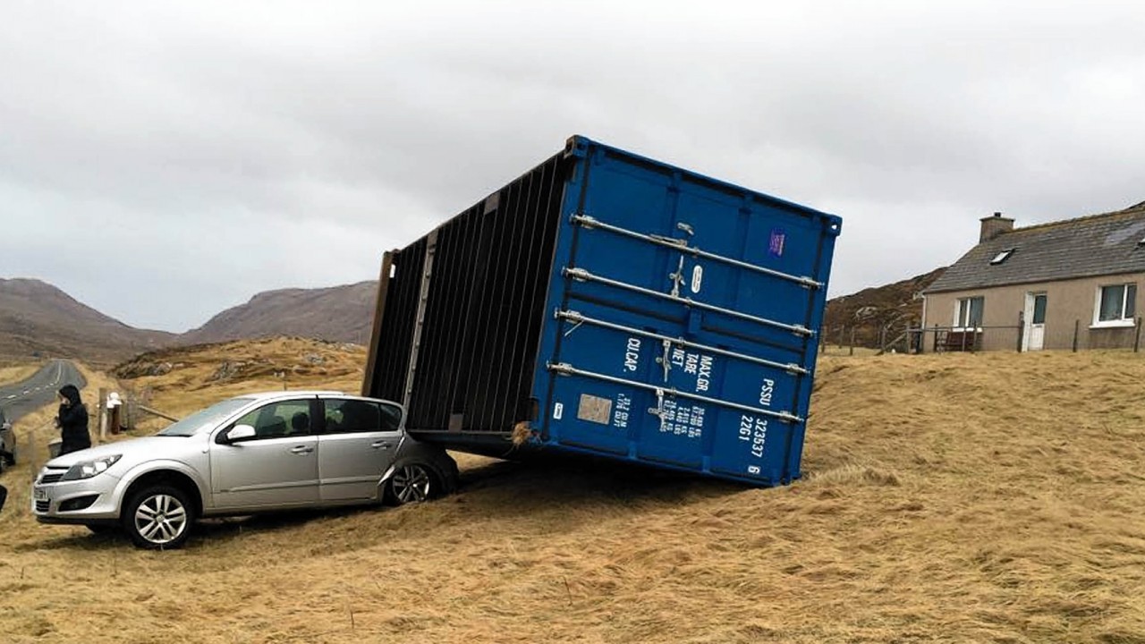 A shipping container weighing two-and-a-half tonnes crushed a car as it was blown 80ft by hurricane-force winds.