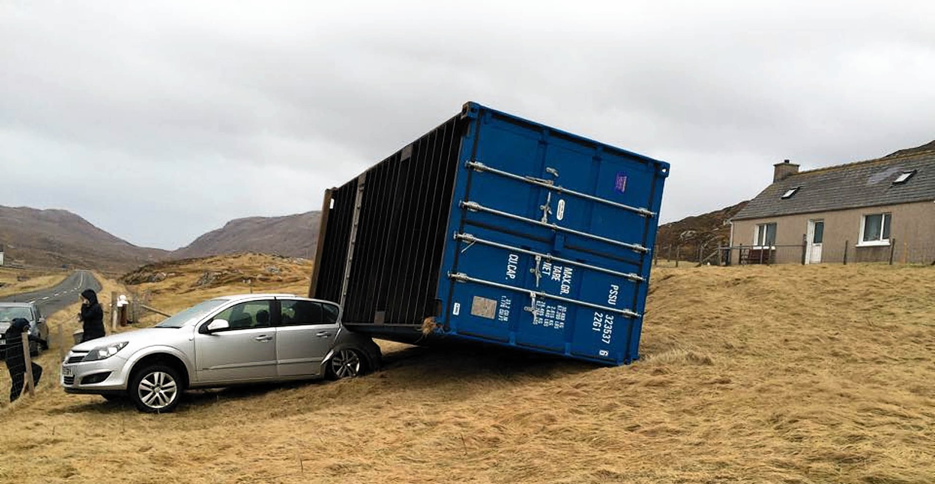 A shipping container weighing two-and-a-half tonnes crushed a car as it was blown 80ft by hurricane-force winds.