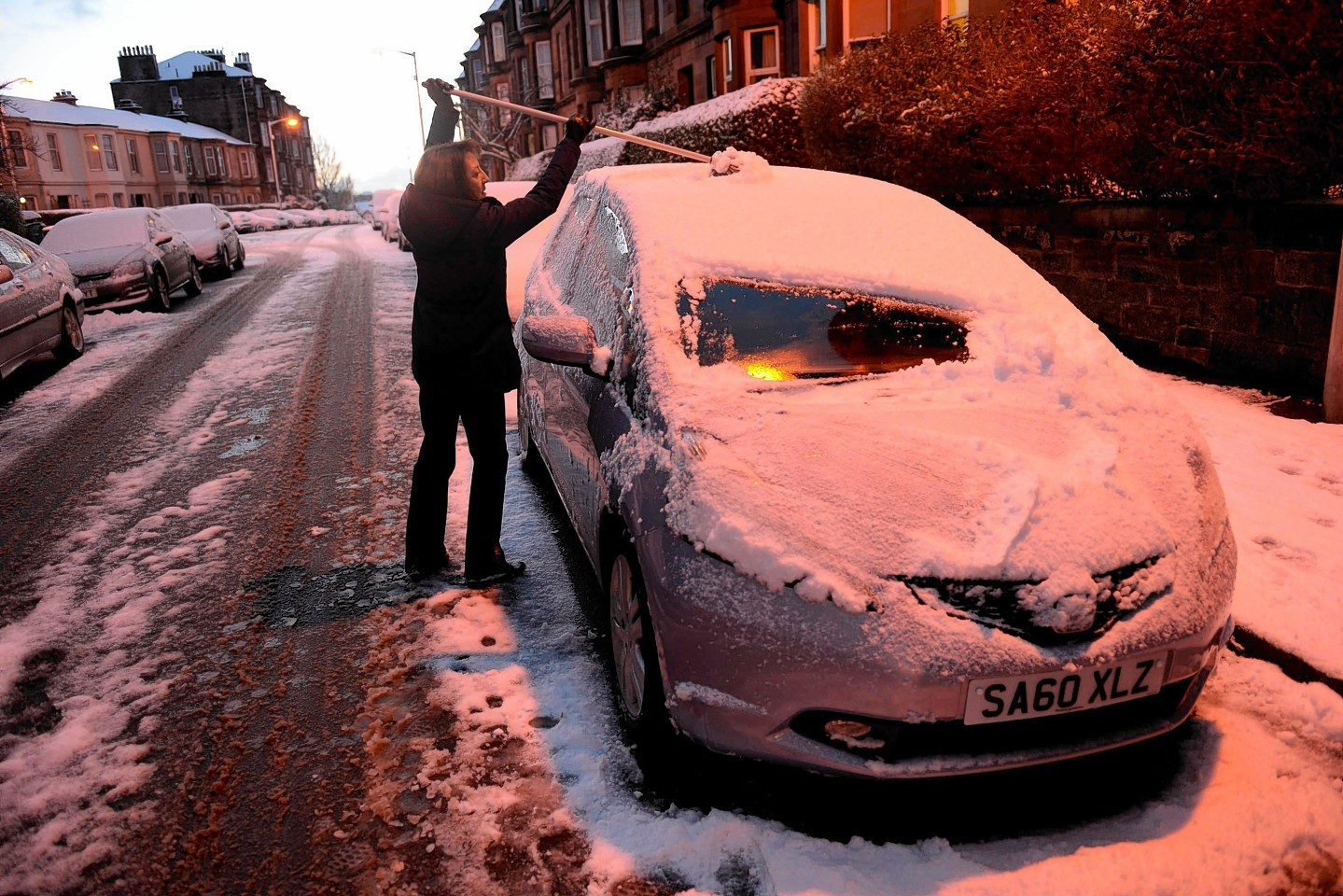 A woman scraped snow form her car in Glasgow 