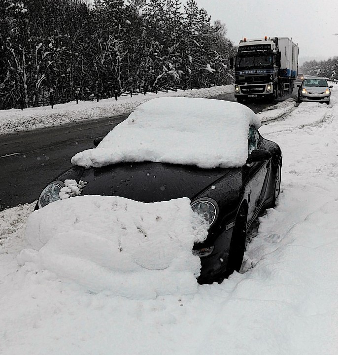 The Porsche was left at the Drumochter Pass... and has since been covered in snow