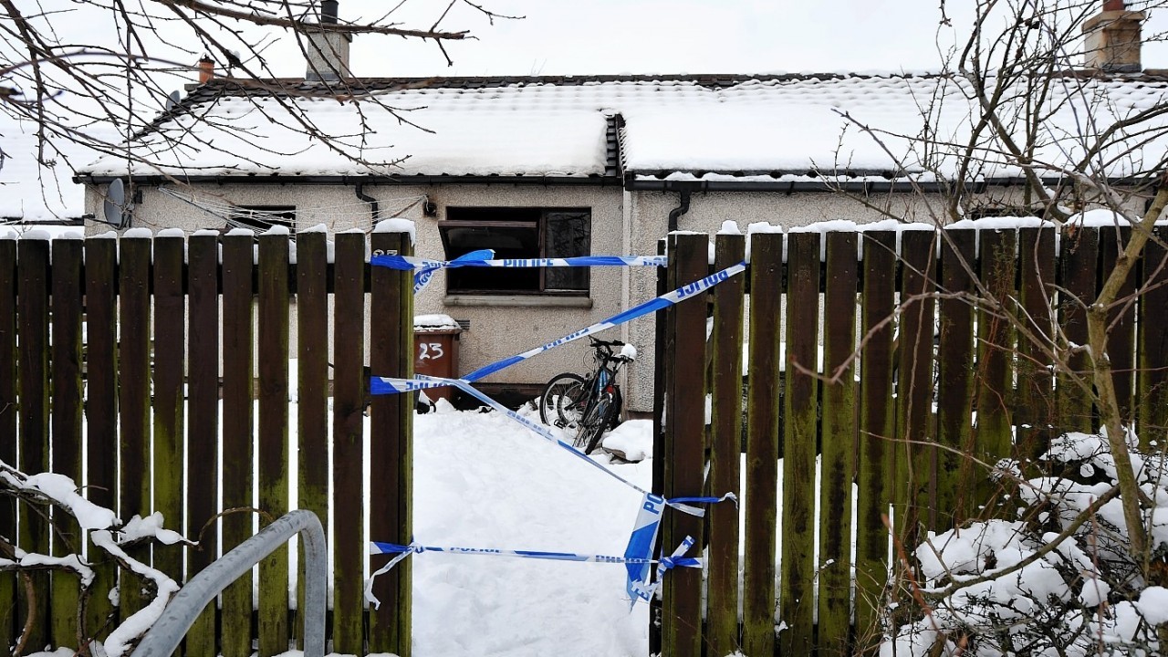 Police and fire services at the burnt out house in Aviemore where a man has been found dead
