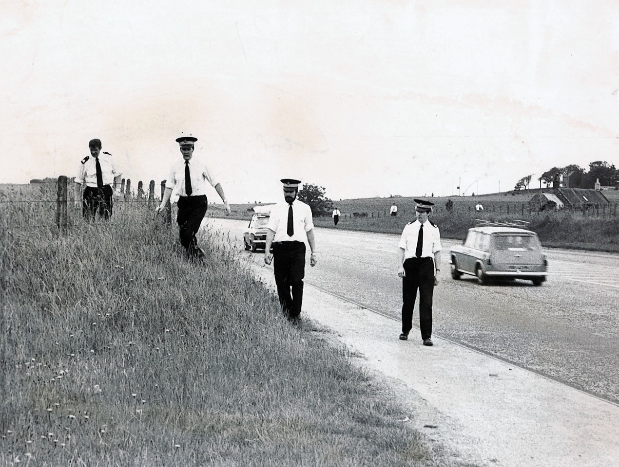 Police search the road from Aberdeen to Stonehaven looking for evidence to solve the murder.