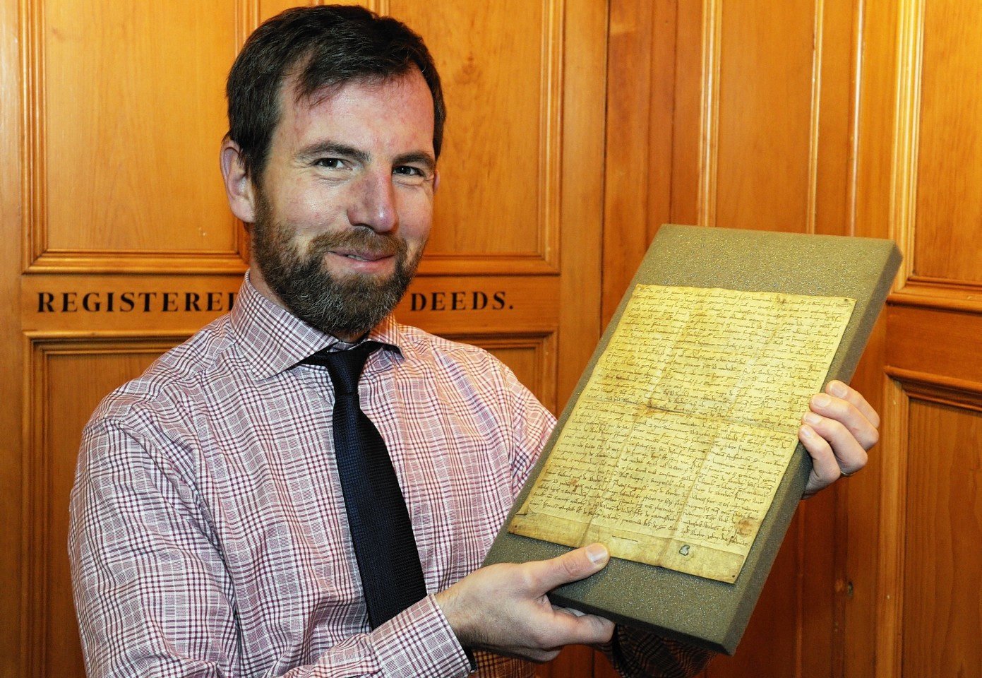 Phil Astley with the Charter from 1214 which details the rights given to Burgesses.