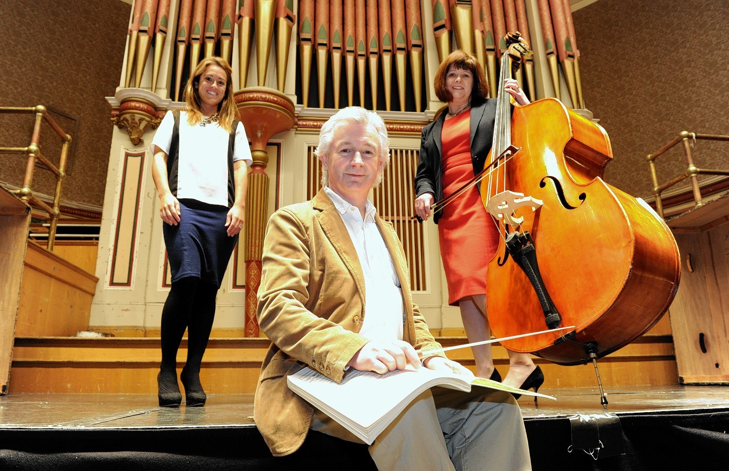 Conductor Gareth John with Friends of Anchor Fundraising Manager Sarah-Jane Hogg (left) and cancer survivor Shona Owen.