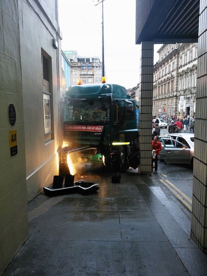 Possibly the first photo taken after the Glasgow bin lorry crash shows the driver slumped over the wheel. Photo courtesy of the Sunday Post