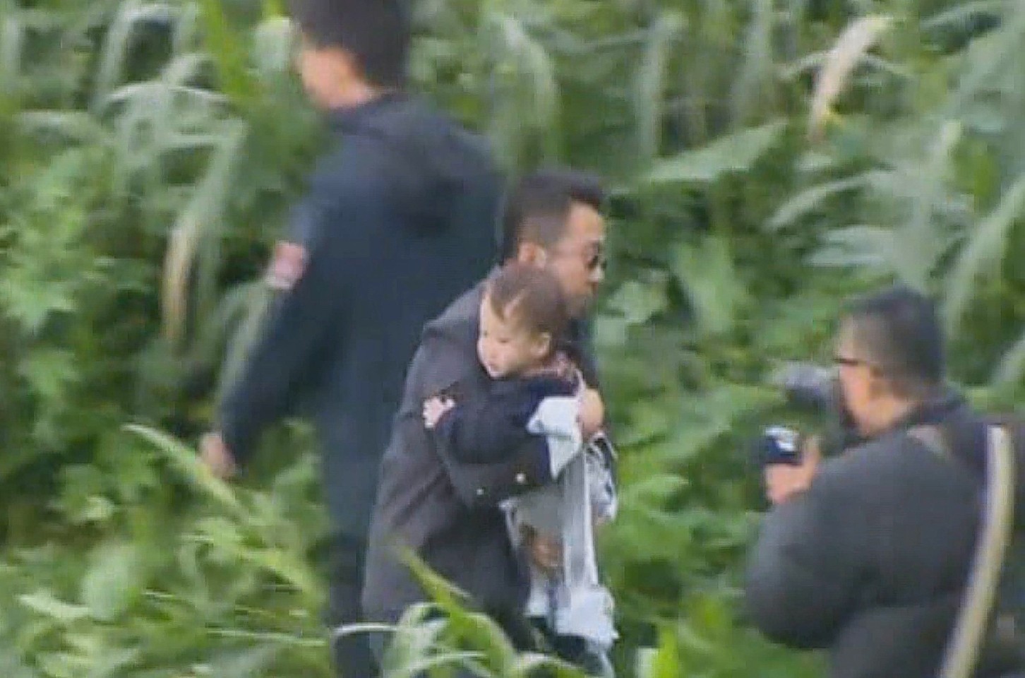 The child is rescued from the plane after it crashed into the river