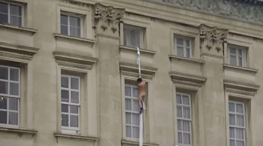 The man appears to be climbing from a window