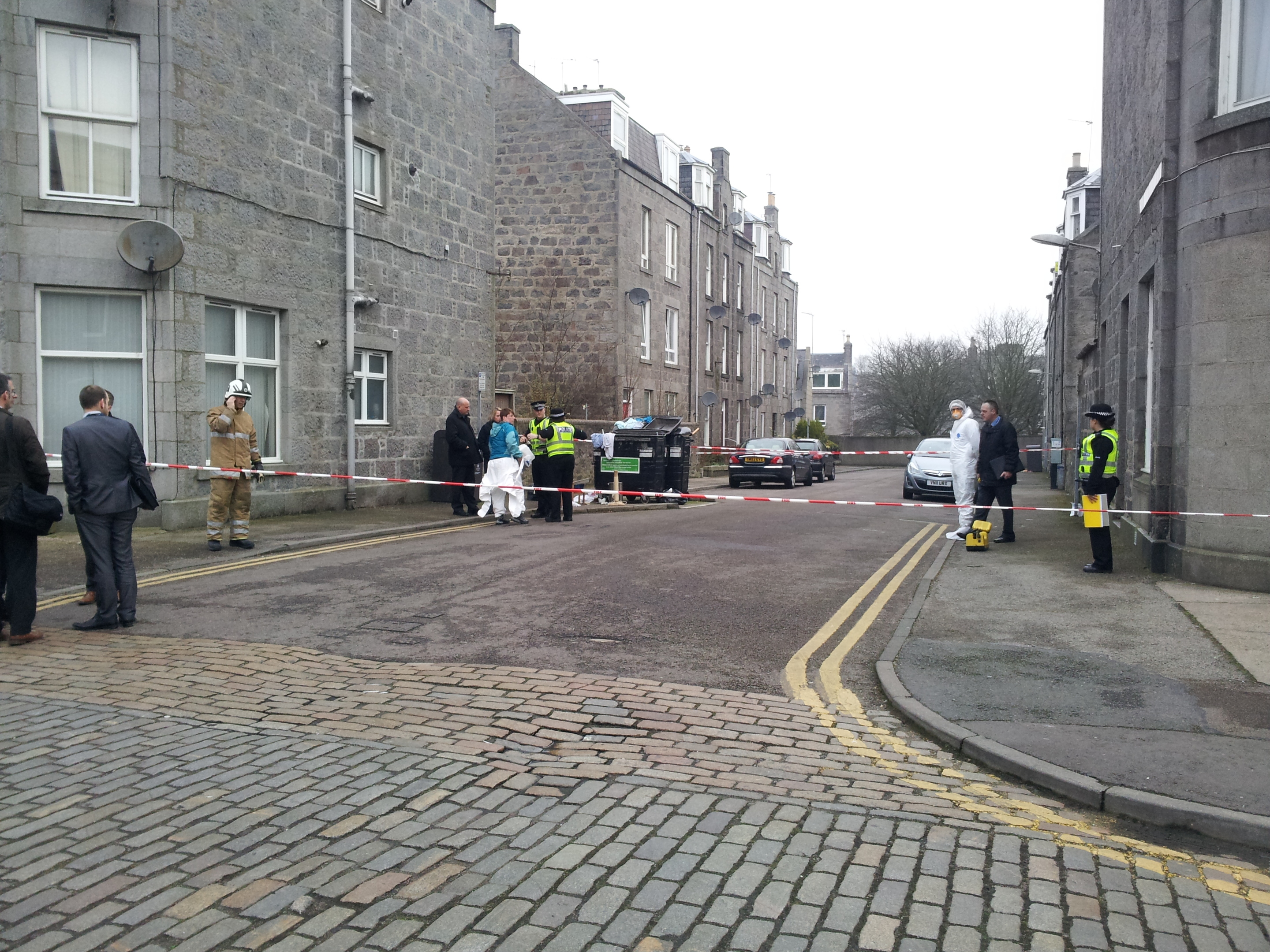 Investigators and fire crews at the scene of the fire on Summerfield Terrace