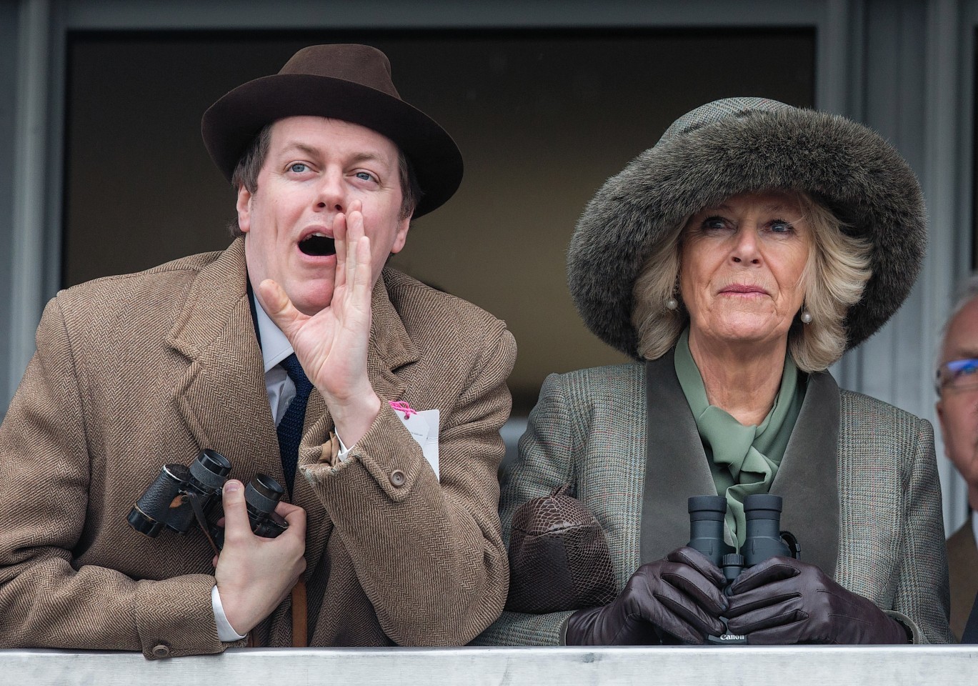 Camilla, Duchess of Cornwall watches a race from the temporary Royal Box with her son Tom Parker Bowles