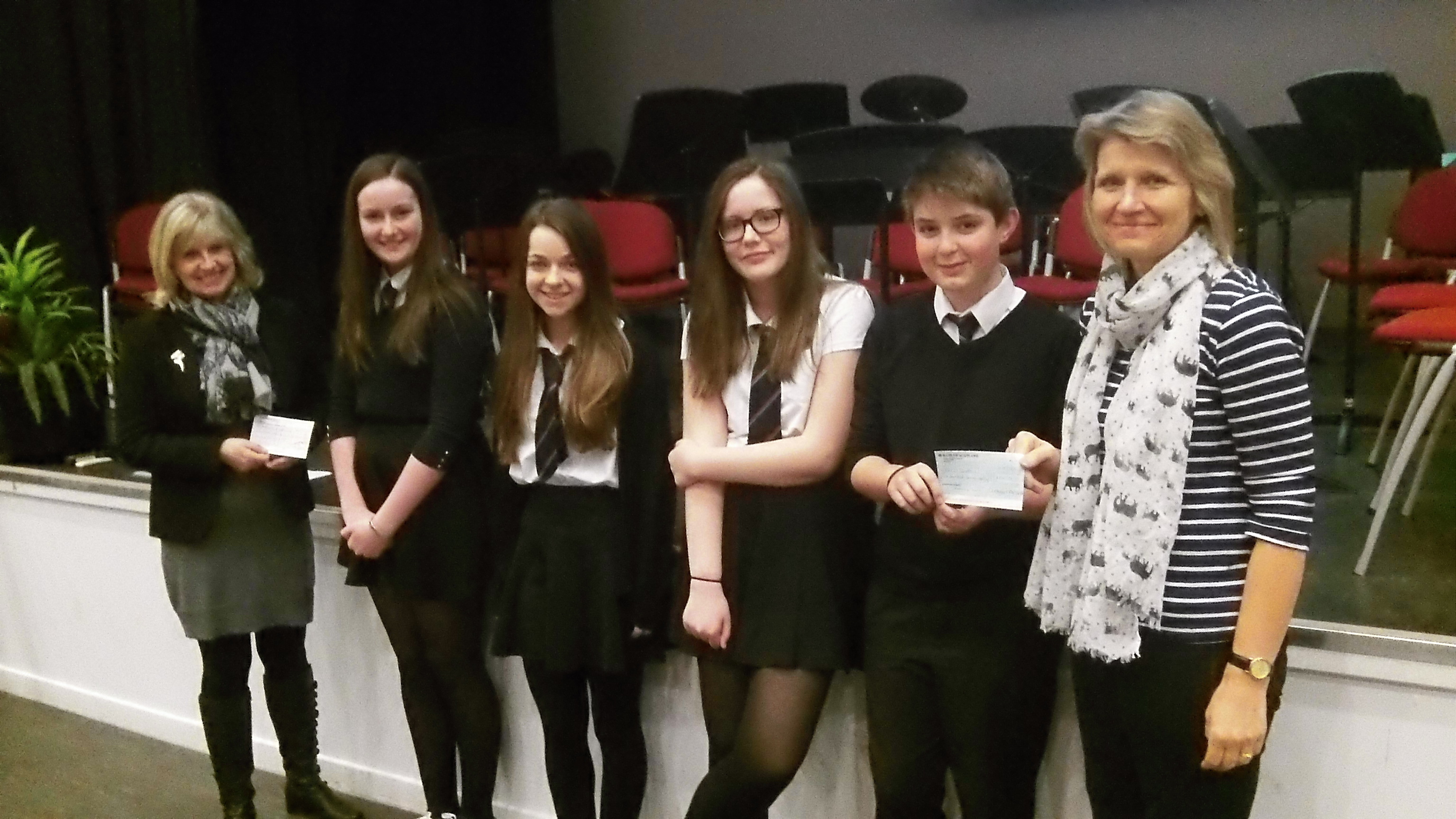 Portlethen Academy pupils Cara Bremner, Jasmine Collett, Craig McLennan and Kirsty Ross handing the cheque over to NEEDS
