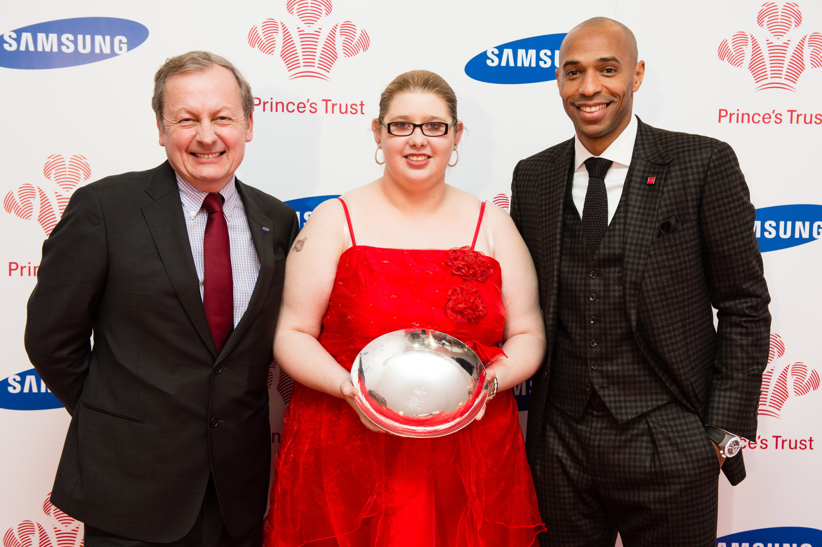 Ms Cheyne collects her prize from Thierry Henry