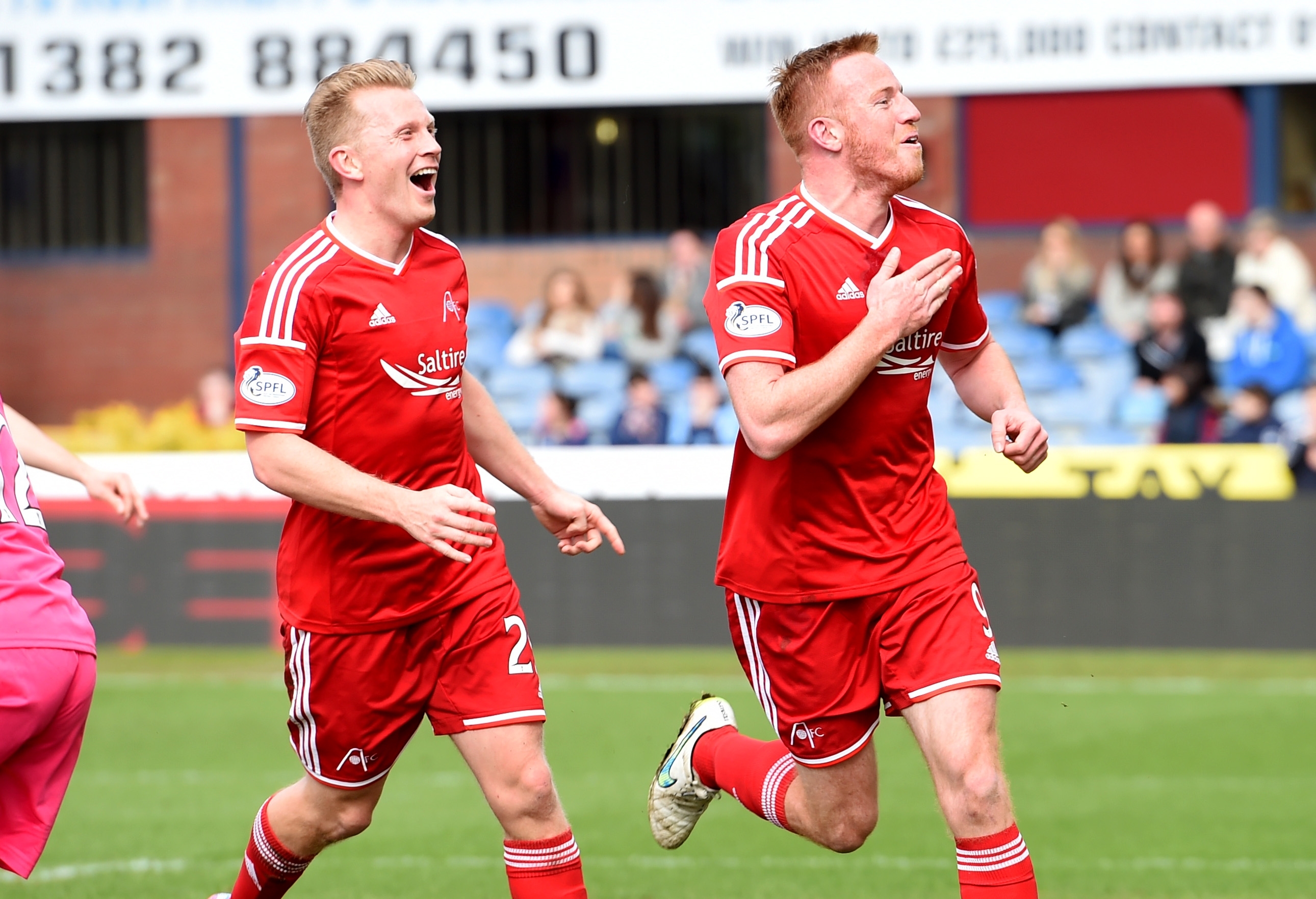 Andrew Driver and Adam Rooney celebrate after the duo combined for the opening goal