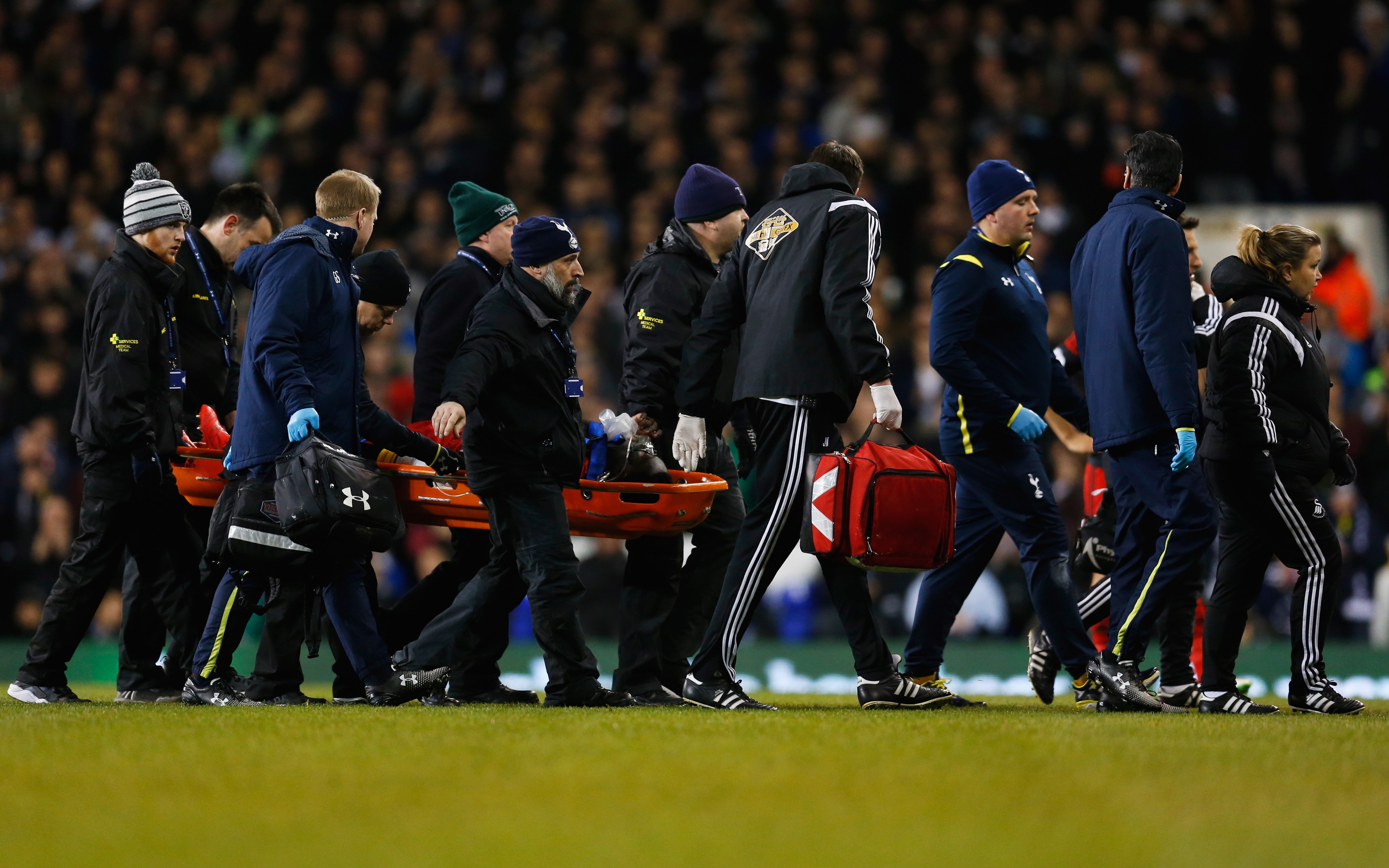 Bafetibis Gomis of Swansea City is stretchered off during the Barclays Premier League match between Tottenham Hotspur and Swansea City at White Hart Lane