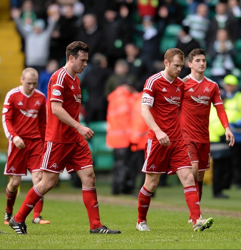 Dejected Dons players trudge off the Parkhead pitch on Sunday