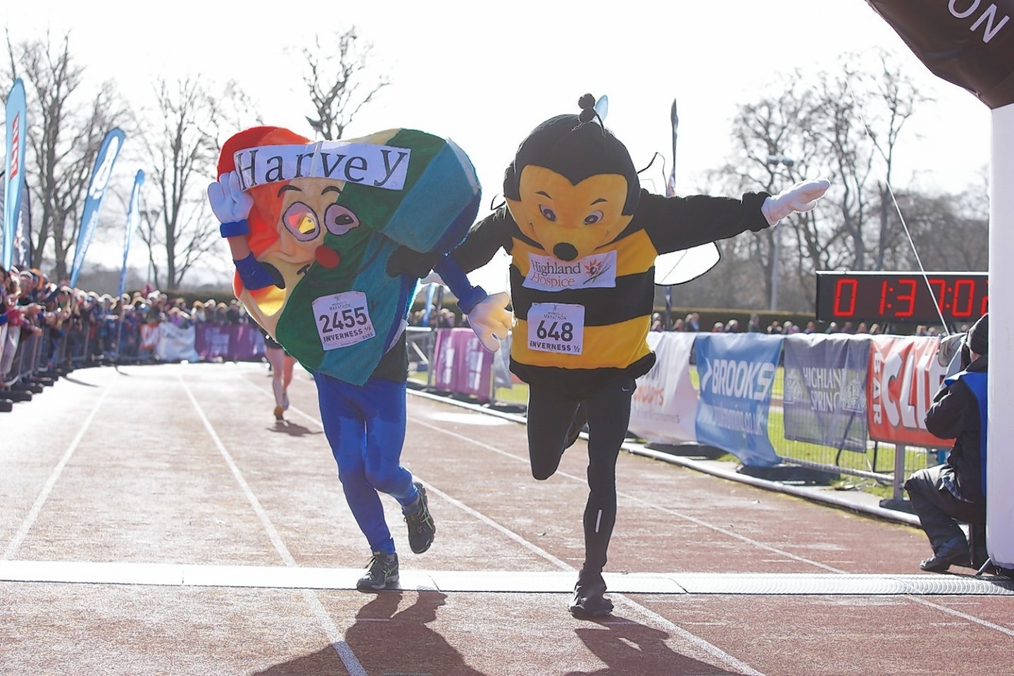 Harvet the Heart and Bobby the Bee cross the finishing line