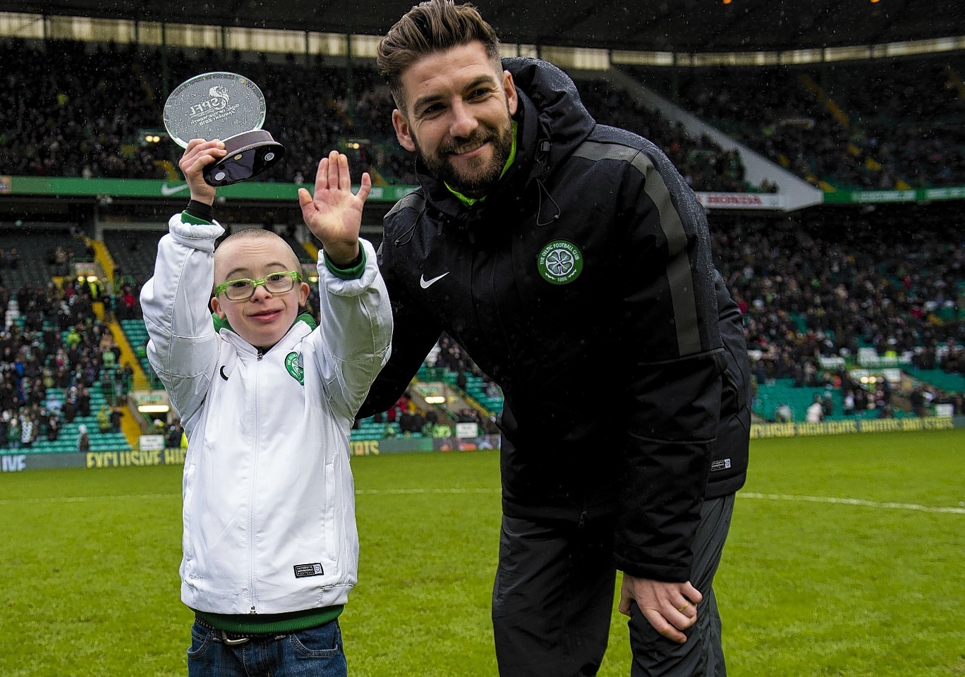 Jay receives his goal of the month award from Celtic's Charlie Mulgrew