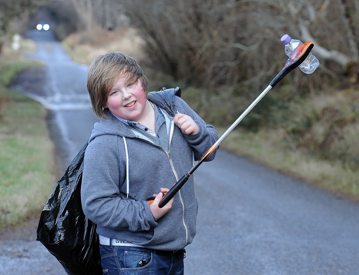 Twelve year old Joe-McCarvill-Ellis of Foyers at work picking up litter between Dores and Foyers