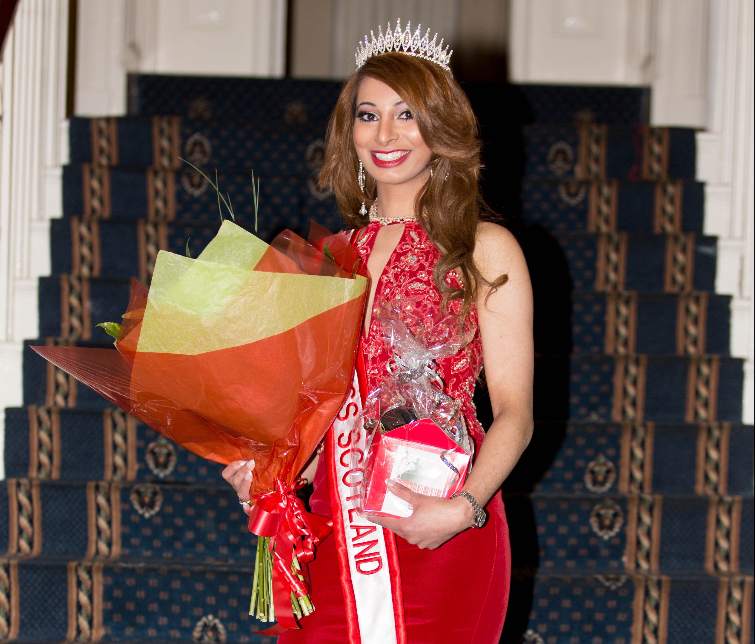 Madiha Iqbal posing triumphantly after becoming Miss Progress Scotland