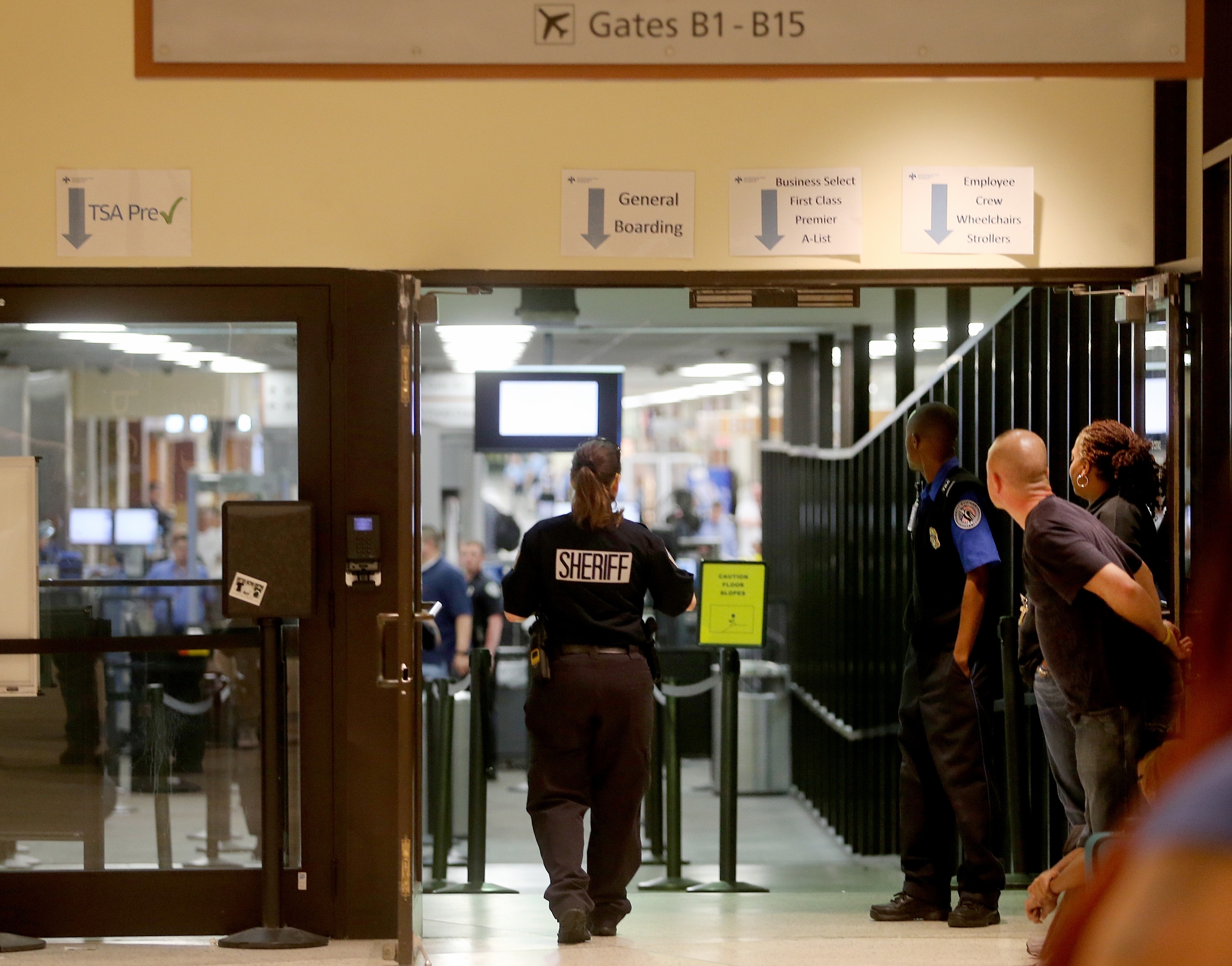 Police investigate on Concourse B of New Orleans Louis Armstrong International Airport after a machete-wielding man was shot