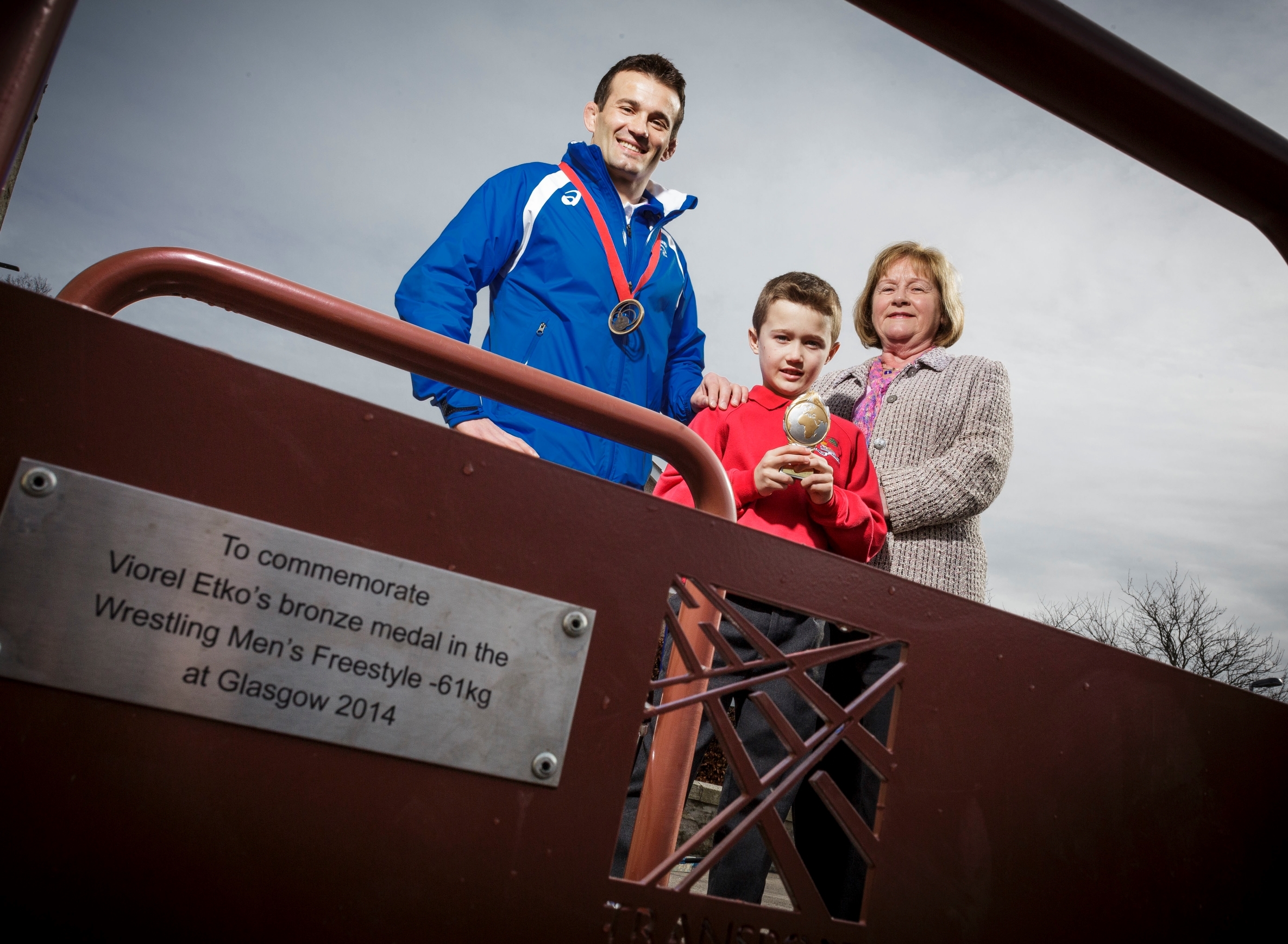 Wrestling champion Viorel Etko and son Leon joined Maureen Watt MSP unveil a commemorative bronze bike stand at Meldrum Primary in recognition of his Commonwealth Games success