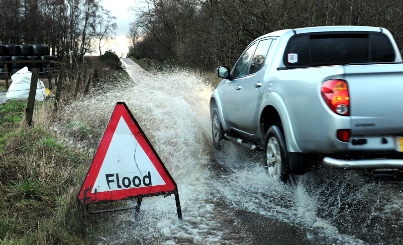 A driver negotiates surface water in Miltimber last January.